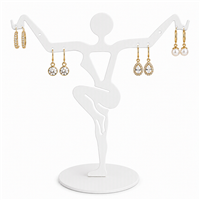 White metal earring display stand holding three pairs of earrings
