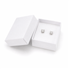 White cardboard earring jewelry box with stud earrings