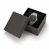 Black paper watch and bangle box with black pillow and wristwatch