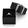 Black ring jewelry box with silver bow and ring