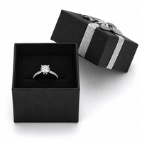 Black ring jewelry box with silver bow and ring