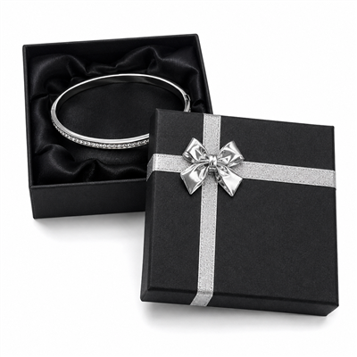 Black bangle jewelry box with silver bow and bracelet