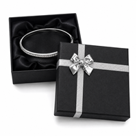 Black bangle jewelry box with silver bow and bracelet