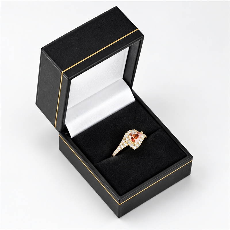 Black leatherette ring box with gold trim and velvet insert